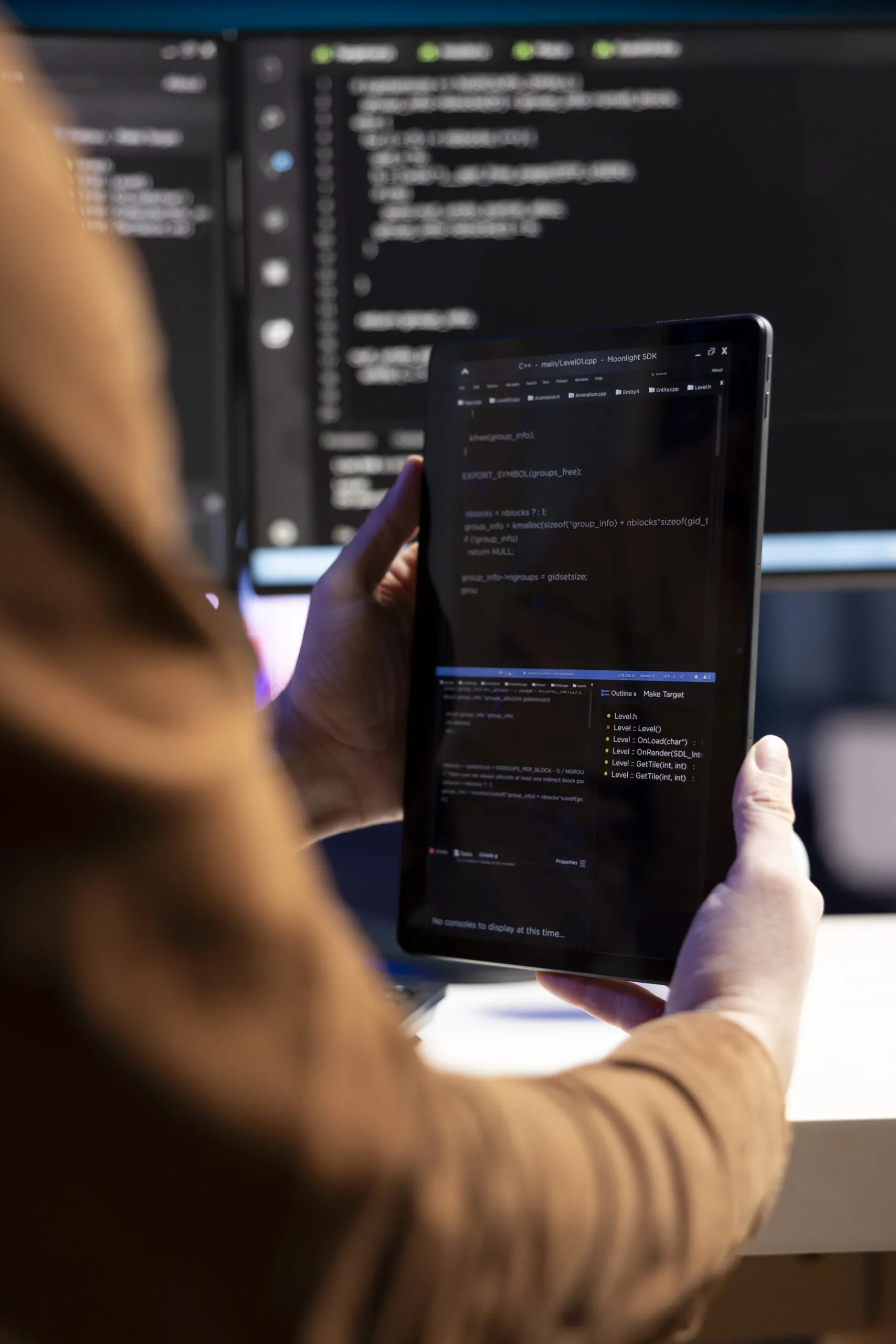 programmer designing and developing software using tablet